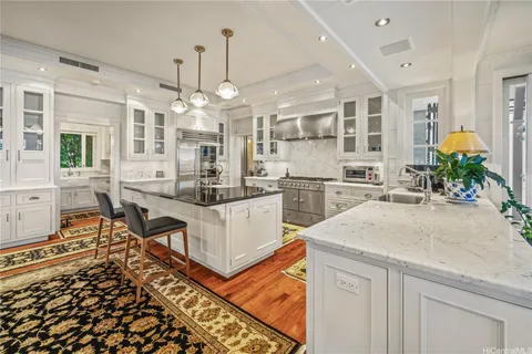 a kitchen with stainless steel appliances granite countertop a sink stove and refrigerator