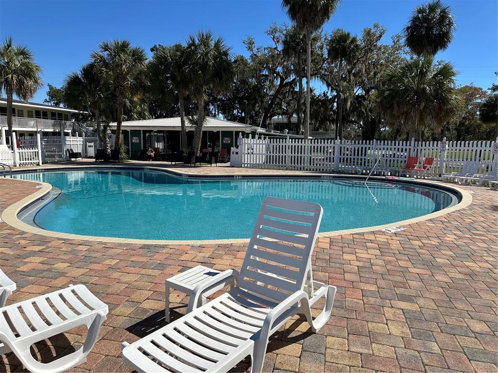 5297 South Cherokee Way, Unit 104 Homosassa, FL 34448 - Photo 16 of 27 a view of a swimming pool with lounge chairs