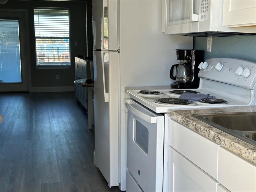 5297 South Cherokee Way, Unit 104 Homosassa, FL 34448 - Photo 2 of 27 a kitchen with a stove and a wooden floor
