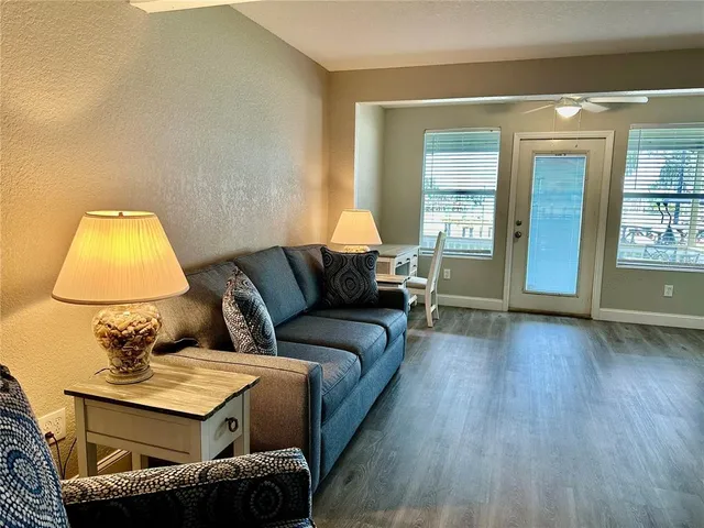 a living room with a couch and wooden floor