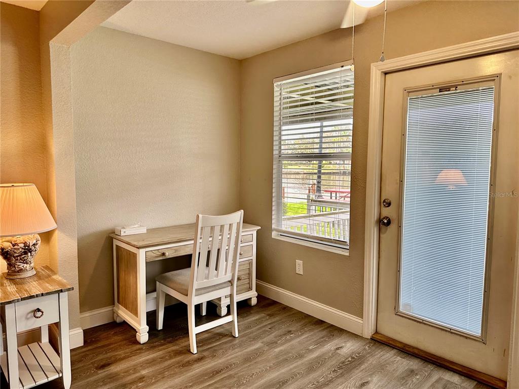 5297 South Cherokee Way, Unit 104 Homosassa, FL 34448 - Photo 7 of 27 a room that has a chair and a table in it