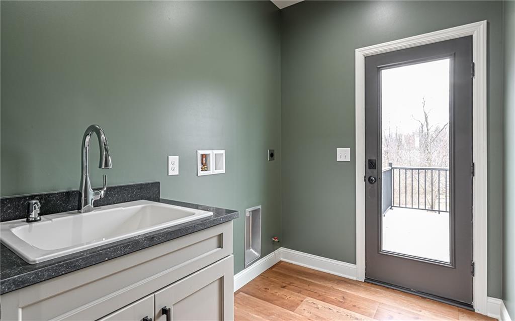 1773 Locust Road Sewickley, PA 15143 - Photo 14 of 34 Main level laundry with utility sink and both electric and gas dryer connections. Door to oversized deck.