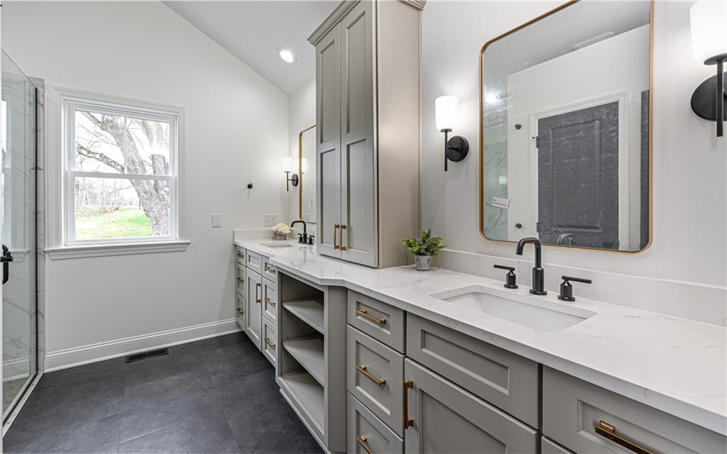 1773 Locust Road Sewickley, PA 15143 - Photo 19 of 34 Primary on suite bathroom with custom soft close doors and drawers, double bowl vanity with linen tower and quartz sink top.