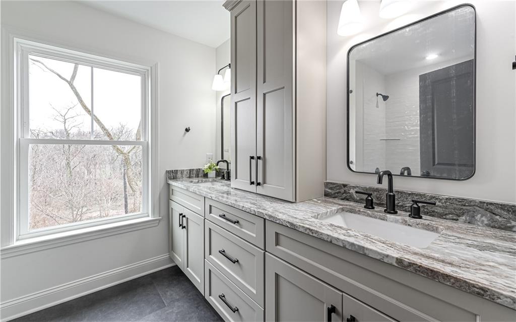 1773 Locust Road Sewickley, PA 15143 - Photo 25 of 34 Second floor bathroom features tub with subway tile walls, double bowl vanity with soft close doors and drawers, linen tower and quartz sink top.