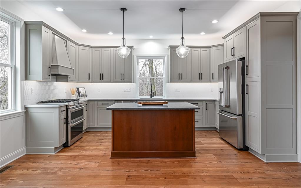 1773 Locust Road Sewickley, PA 15143 - Photo 5 of 34 Custom cabinetry with inset doors, soft close drawers, doors & pull out shelving. Quartz countertops and subway tile backsplash.