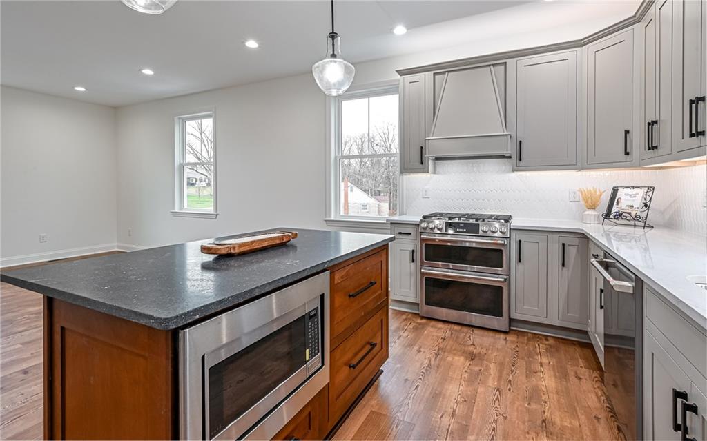 1773 Locust Road Sewickley, PA 15143 - Photo 6 of 34 Double oven with six burner gas top and built in exhaust hood. Under counter microwave in center island. Lazy susan and built in cutlery organizer.