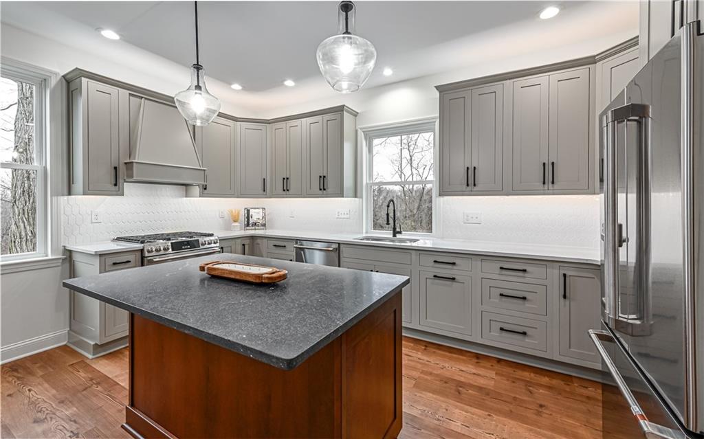 1773 Locust Road Sewickley, PA 15143 - Photo 8 of 34 Contrasting center island with room for bar stools and pendant lighting.