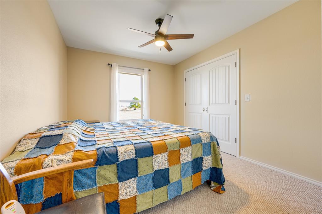 3418 Fm 38 Street North Brookston, TX 75421 - Photo 14 of 22 a bedroom with a bed and a chandelier