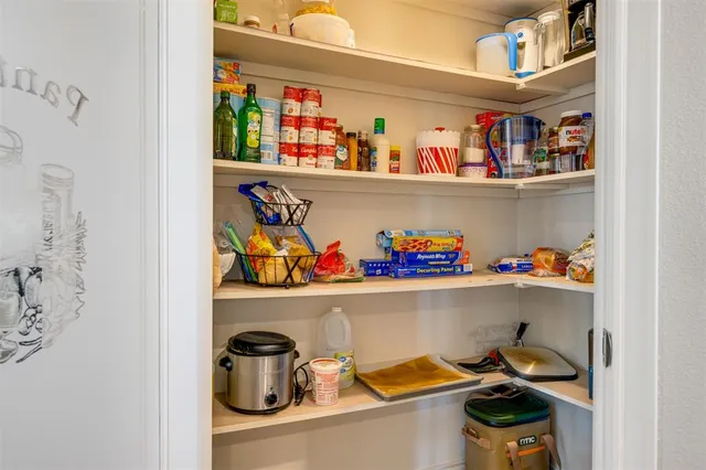 a shelf with cup and plates