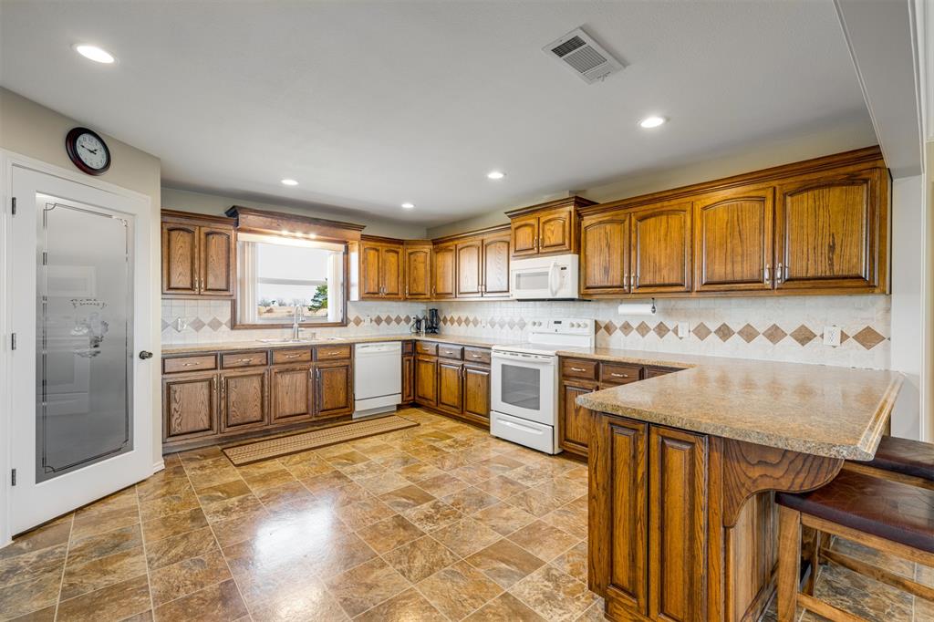 3418 Fm 38 Street North Brookston, TX 75421 - Photo 6 of 22 a kitchen with a stove sink and cabinets
