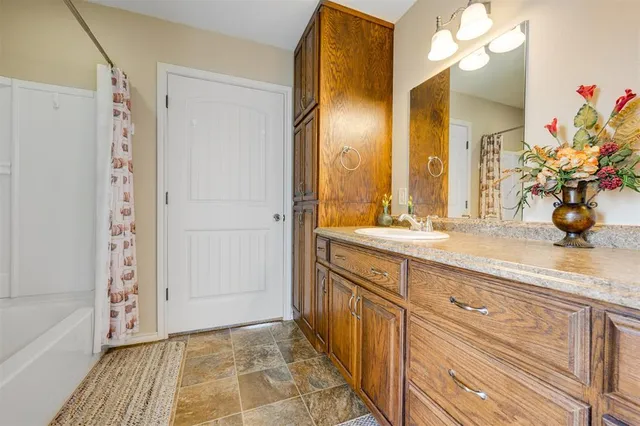 a bathroom with a double vanity sink mirror and shower