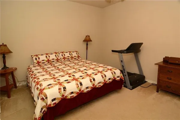 a bed sitting in a bedroom next to a window