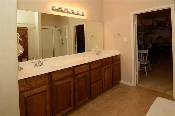 a spacious bathroom with a double vanity sink double and mirror