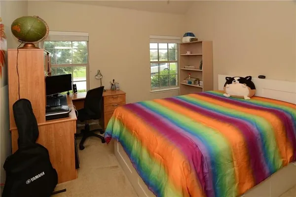 a bedroom with a bed and a large window