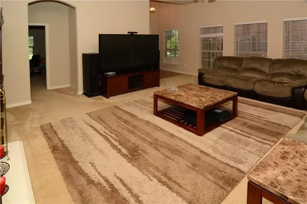 a living room with furniture and a flat screen tv