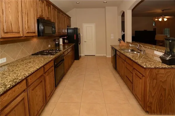 a kitchen with stainless steel appliances granite countertop a stove and a sink