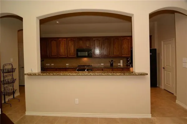 a kitchen with stainless steel appliances a refrigerator and a stove