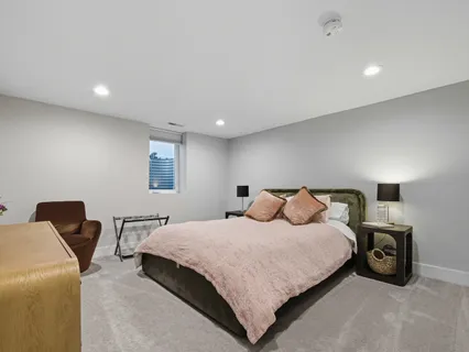 a bedroom with a bed and a chair