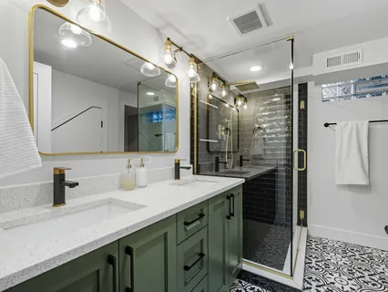 a bathroom with a shower sink and mirror