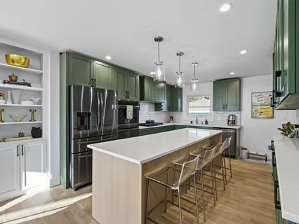a large kitchen with a table and chairs