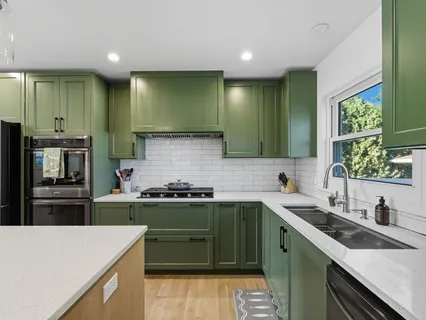 a kitchen with a sink stove and cabinets