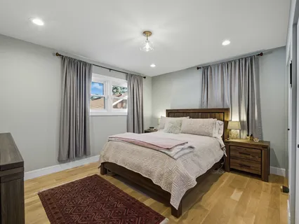 a bedroom with a large bed and a window