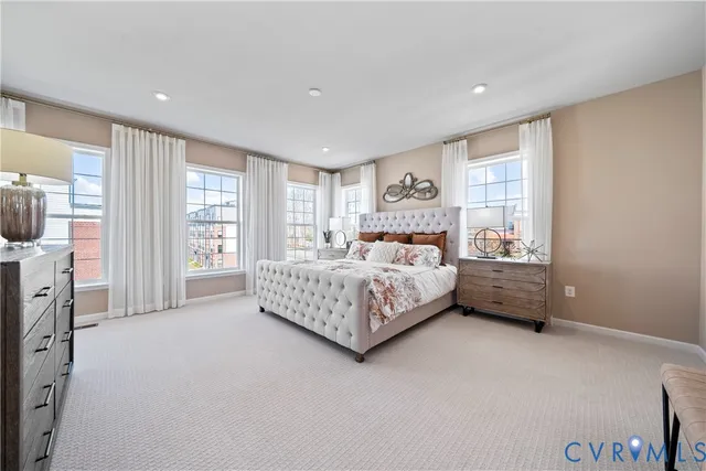 a bedroom with bed and a large window