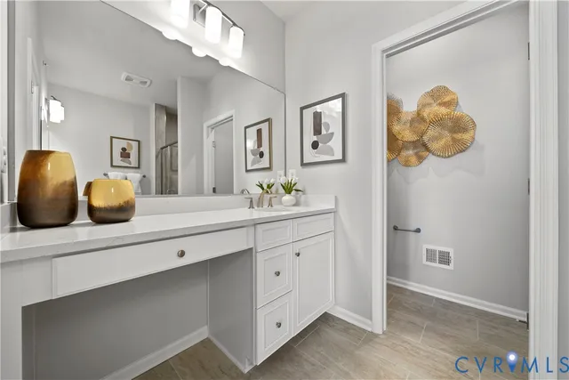 a spacious bathroom with a double vanity sink and a mirror