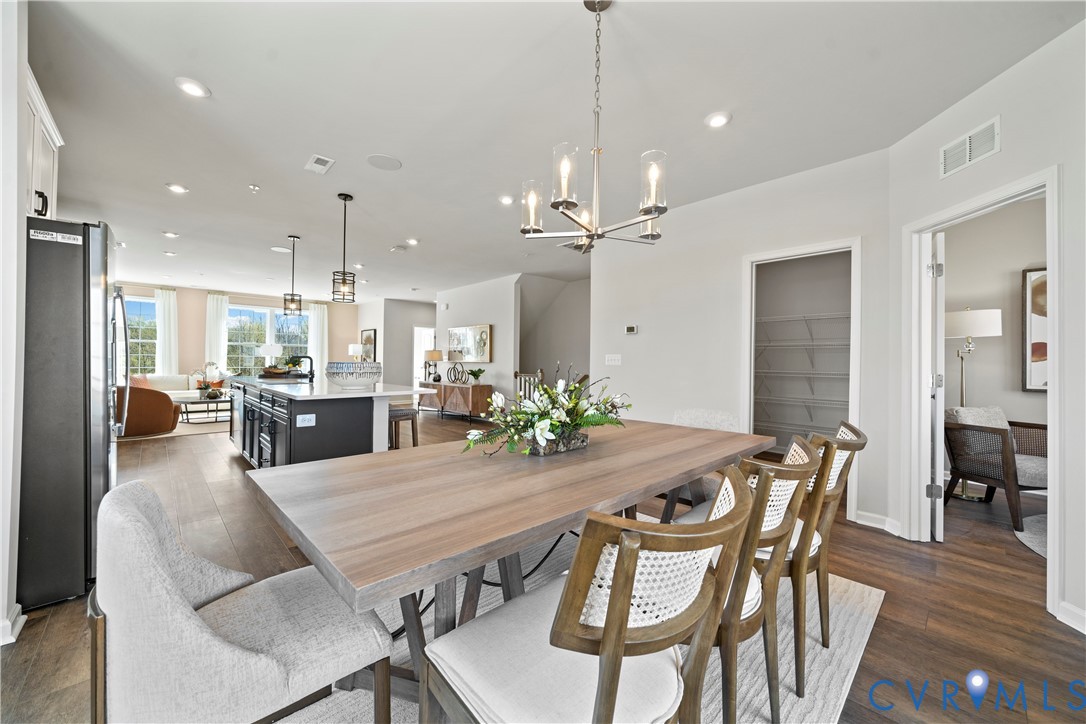 13133 Brattice Loop Midlothian, VA 23114 - Photo 3 of 40 a view of a dining room and livingroom with furniture wooden floor a chandelier