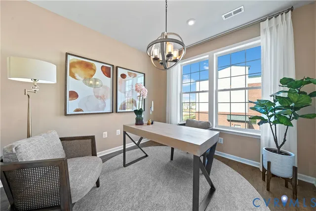 a view of a livingroom with furniture window and wooden floor