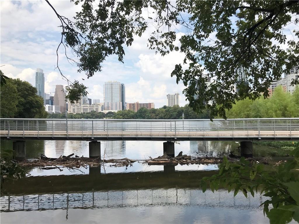 500 East Riverside Drive, Unit 154 Austin, TX 78704 - Photo 1 of 14 Waterfront setting featuring a pedestrian bridge and mature trees