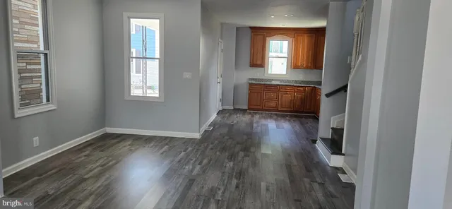 wooden floor in an empty room with a window