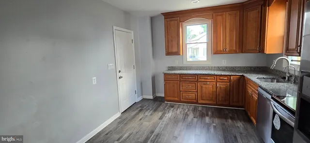 a kitchen with wooden floors and sink