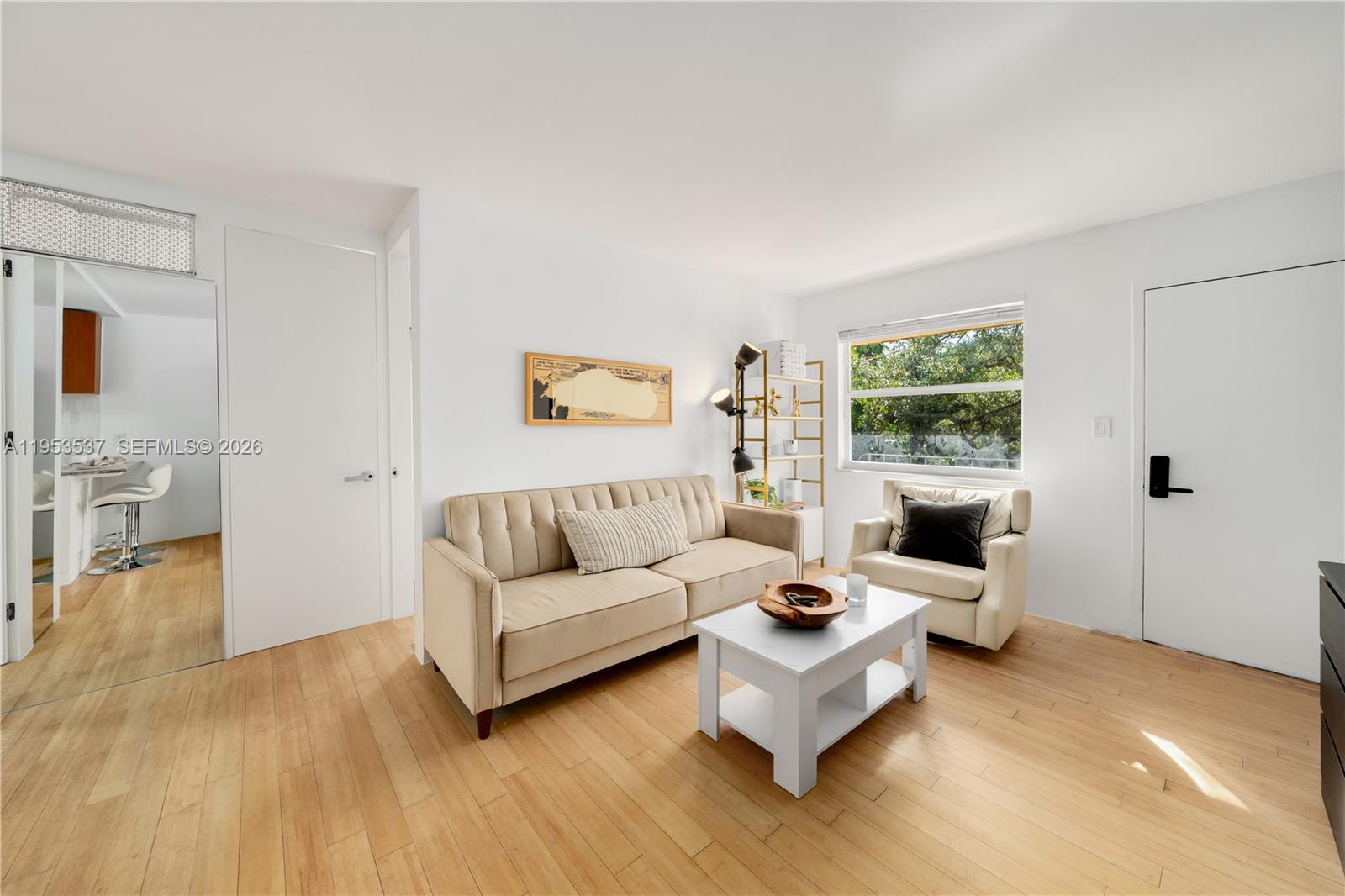 651 Northeast 60th Street, Unit 25 Miami, FL 33137 - Photo 11 of 23 a living room with furniture and a wooden floor
