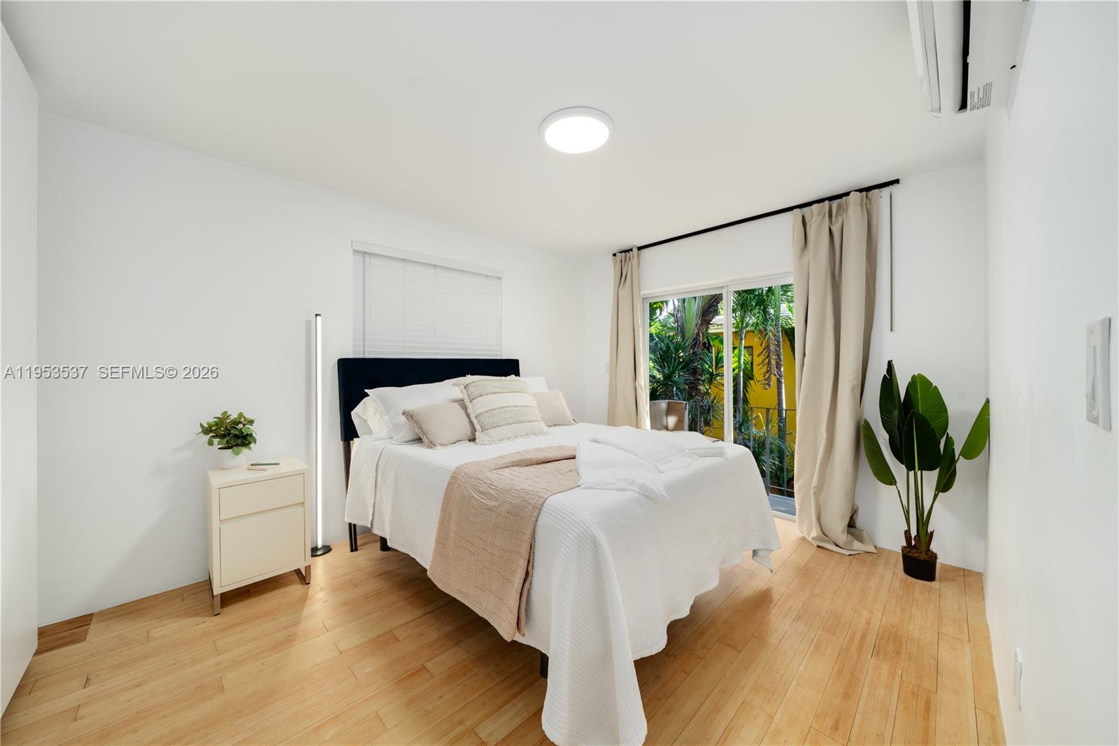 651 Northeast 60th Street, Unit 25 Miami, FL 33137 - Photo 13 of 23 a bed sitting in a spacious bedroom next to a window