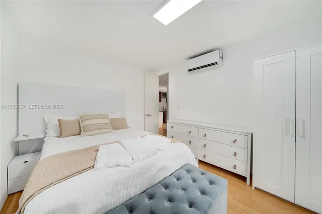 a large white bed in a white room