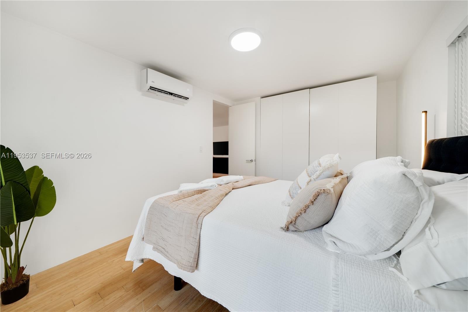 651 Northeast 60th Street, Unit 25 Miami, FL 33137 - Photo 17 of 23 a bedroom with a bed and a potted plant