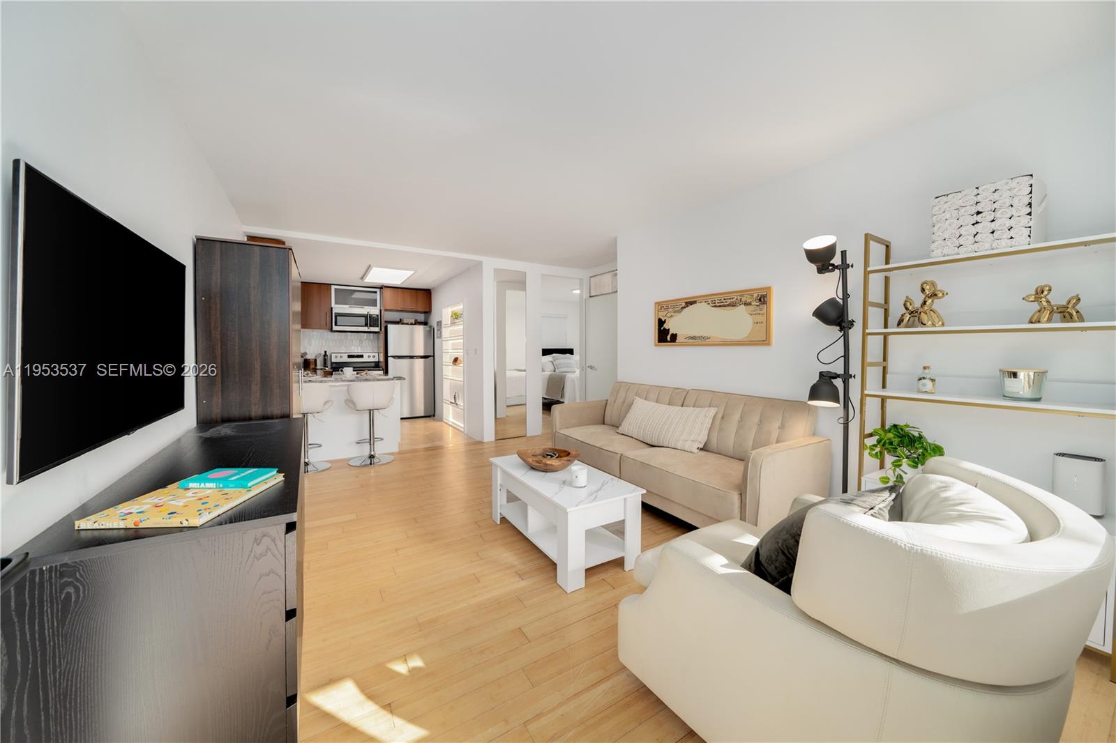 651 Northeast 60th Street, Unit 25 Miami, FL 33137 - Photo 5 of 23 a living room with furniture and a flat screen tv