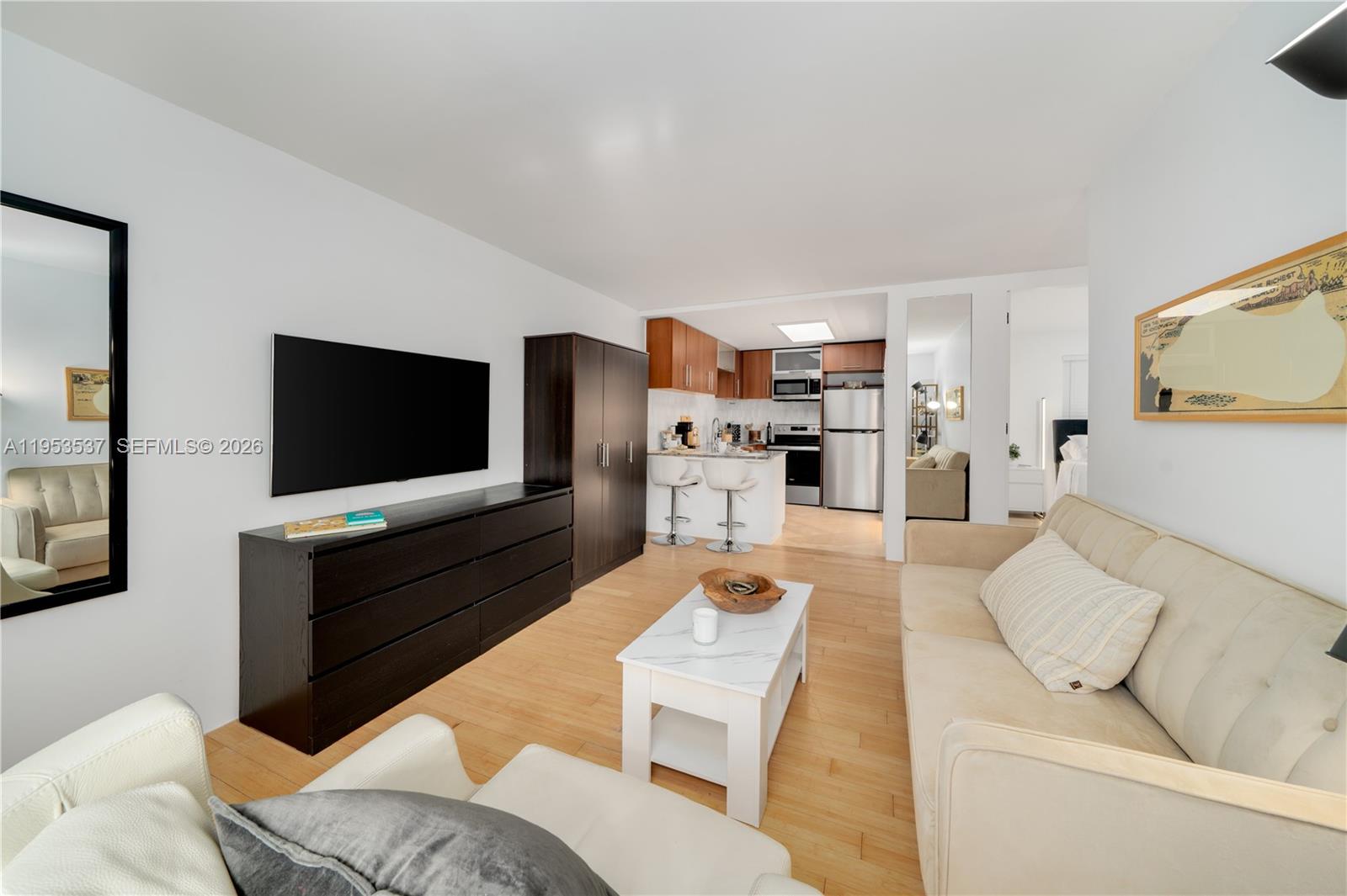 651 Northeast 60th Street, Unit 25 Miami, FL 33137 - Photo 6 of 23 a living room with furniture and a flat screen tv