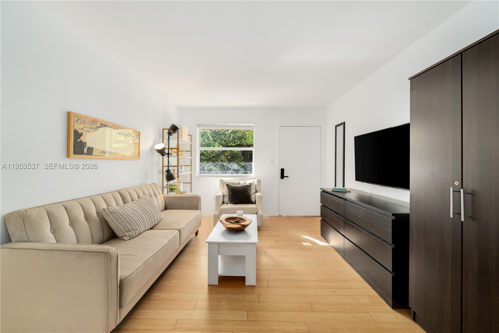 651 Northeast 60th Street, Unit 25 Miami, FL 33137 - Photo 10 of 23 a living room with furniture and a flat screen tv