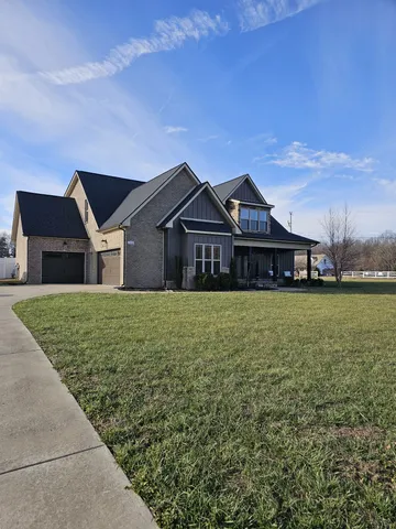 a front view of a house with a garden