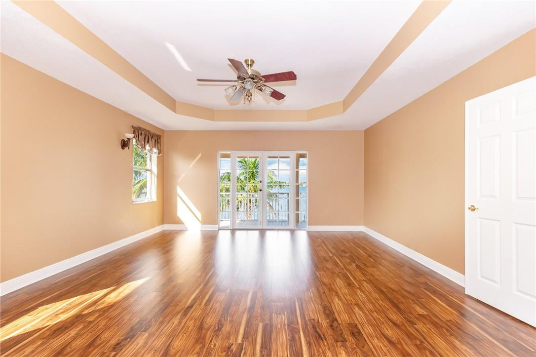 19471 Southwest 39th Street Miramar, FL 33029 - Photo 14 of 50 a view of an empty room with wooden floor and a window