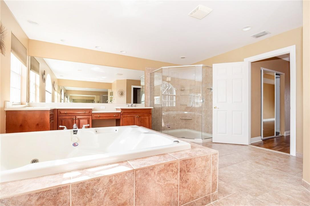 19471 Southwest 39th Street Miramar, FL 33029 - Photo 17 of 50 a spacious bathroom with a tub sink and mirror