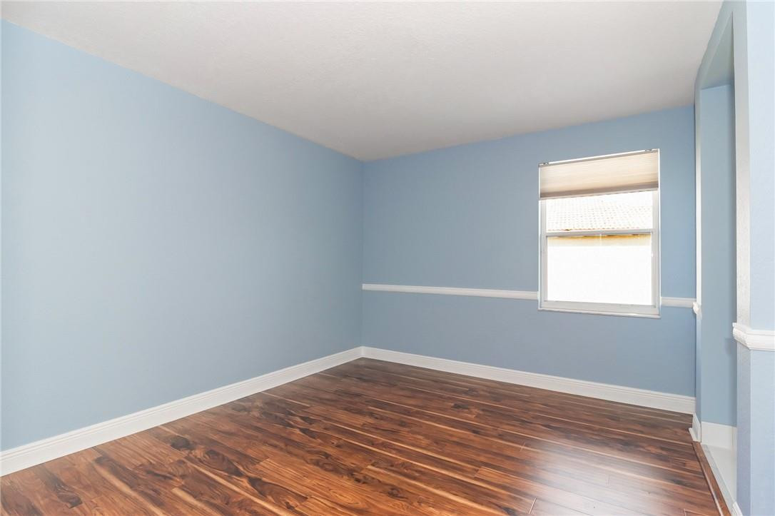 19471 Southwest 39th Street Miramar, FL 33029 - Photo 22 of 50 an empty room with wooden floor and windows