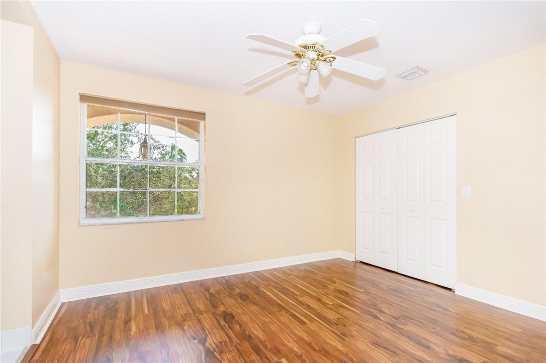 19471 Southwest 39th Street Miramar, FL 33029 - Photo 26 of 50 an empty room with wooden floor fan and windows