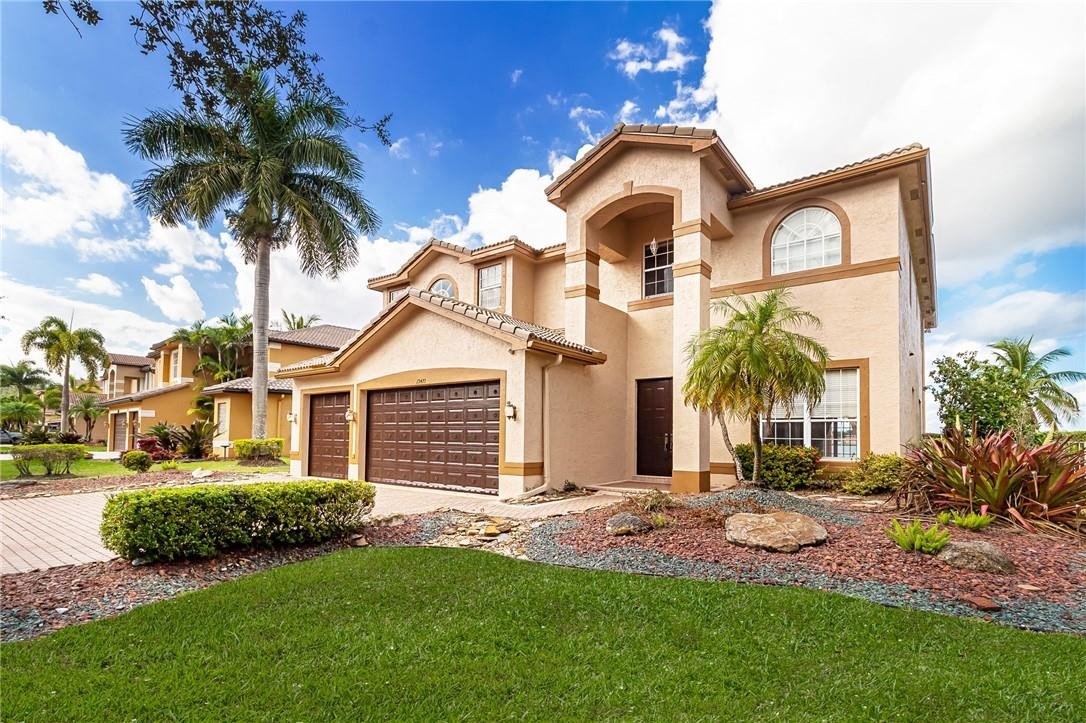 19471 Southwest 39th Street Miramar, FL 33029 - Photo 32 of 50 a front view of a house with a garden and yard