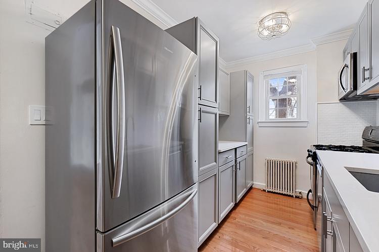3925 Davis Place Northwest, Unit 206 Washington, DC 20007 - Photo 12 of 26 a kitchen with stainless steel appliances a refrigerator and a stove top oven