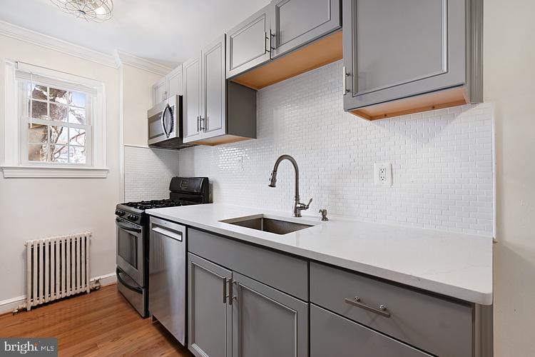 3925 Davis Place Northwest, Unit 206 Washington, DC 20007 - Photo 13 of 26 a kitchen with stainless steel appliances granite countertop a sink and cabinets