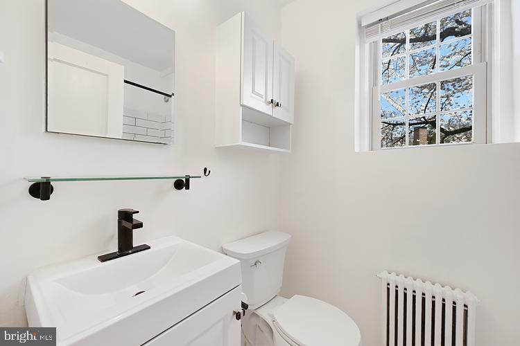 3925 Davis Place Northwest, Unit 206 Washington, DC 20007 - Photo 14 of 26 a bathroom with a sink a toilet and mirror