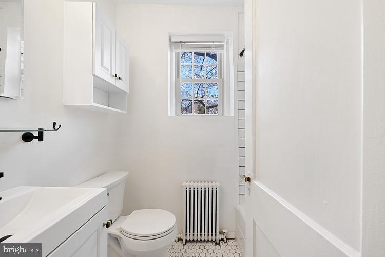 3925 Davis Place Northwest, Unit 206 Washington, DC 20007 - Photo 15 of 26 a bathroom with a toilet a sink and a bathtub